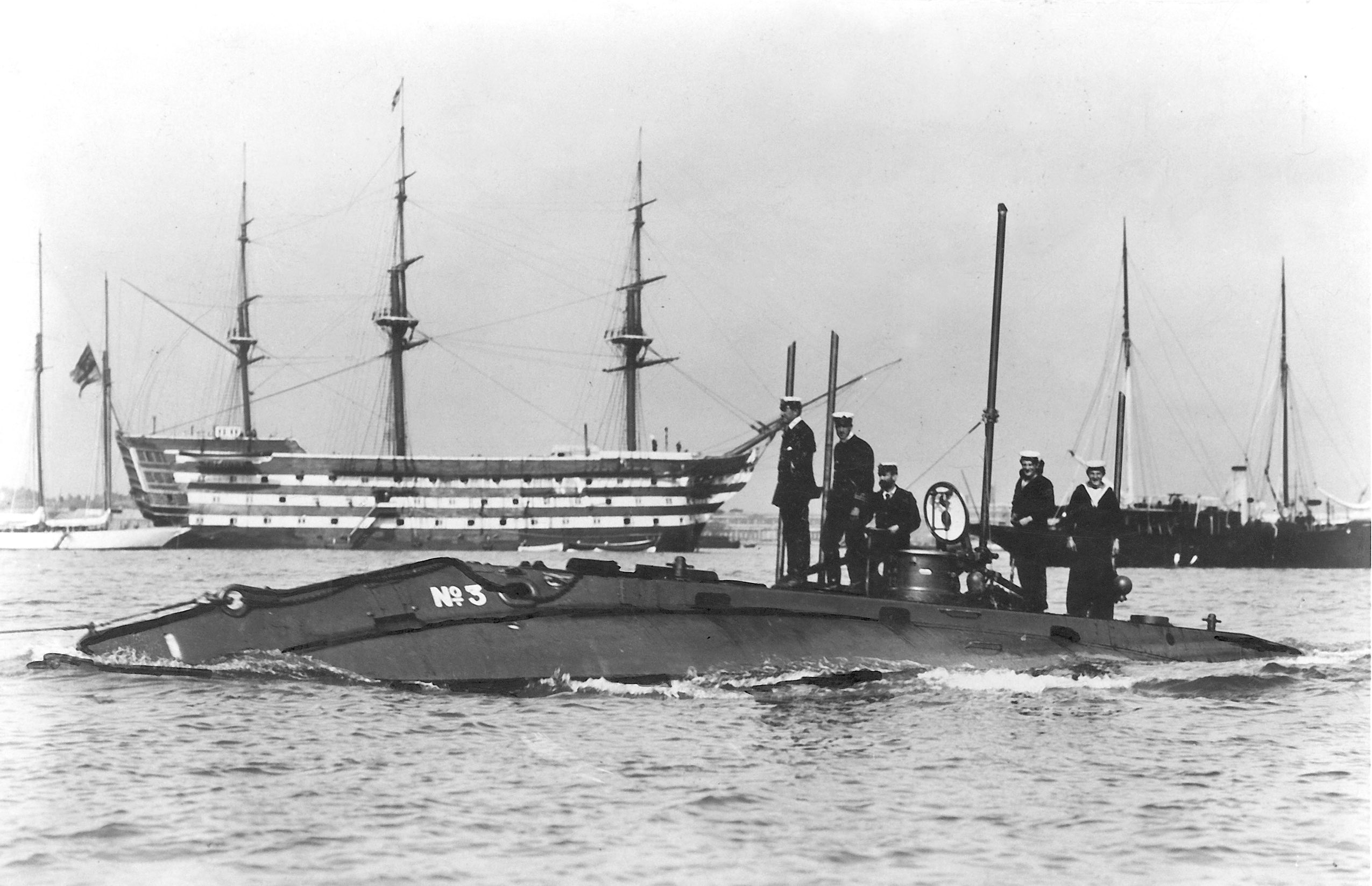 The early British submarine HMS Holland I passes HMS Victory at Portsmouth, sometime in the early 20th Century. Photo: Strathdee Collection.