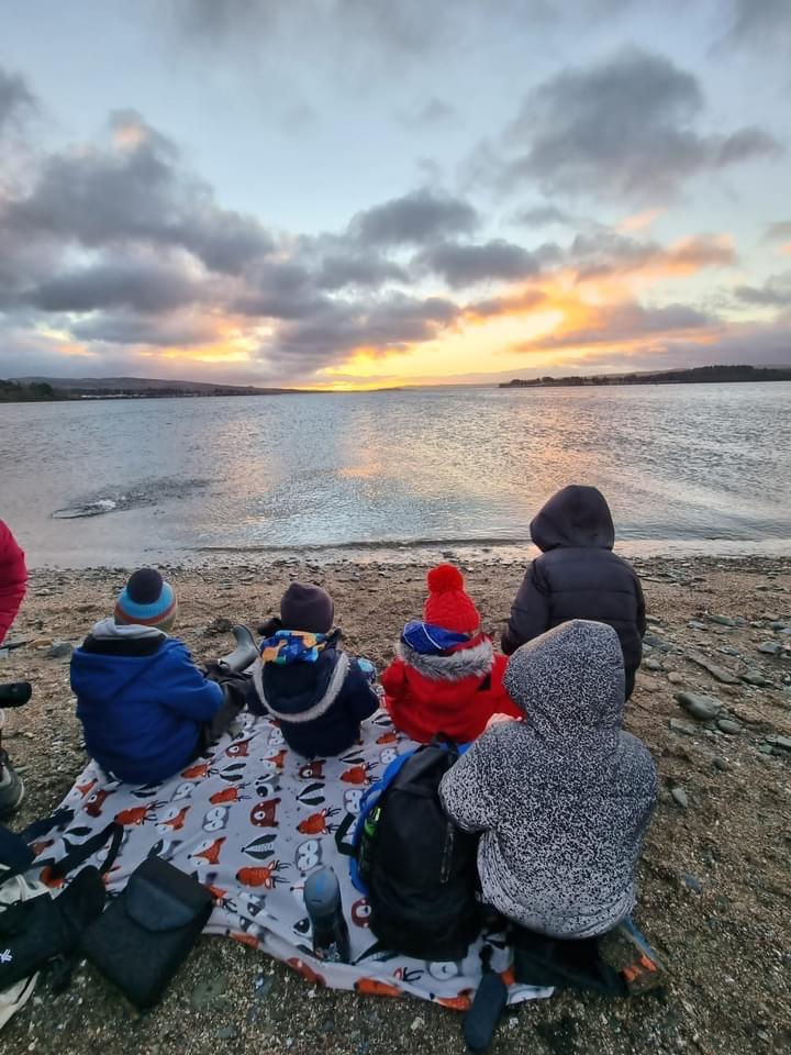 A family sat along a beach.