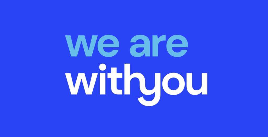 Blue and white next on an indigo background that says 'we are with you', related to supporting veterans.